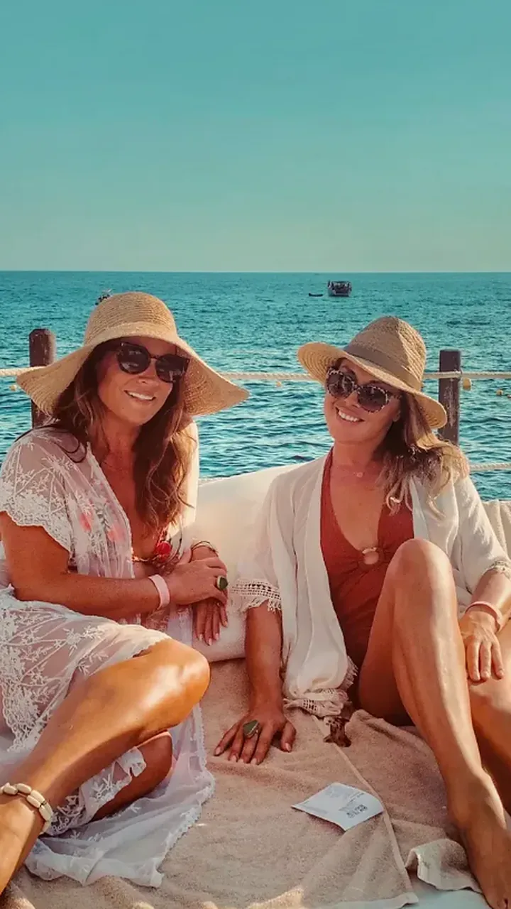 Rayne and a friend sitting on a boat